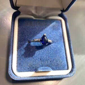 Dark blue sapphire ring with diamond accents